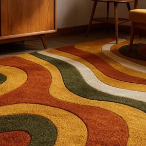 May include: A retro-style area rug with a wavy pattern in shades of orange, yellow, green, and white. The rug's design evokes a 1970s aesthetic, adding a vibrant and textured element to any room. The rug's dimensions are not visible.
