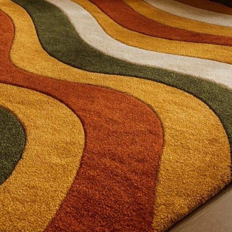 May include: A colorful area rug with a wavy pattern. The rug features bands of olive green, cream, yellow, orange, and rust colors. The rug has a soft, textured appearance and is likely made of a plush material.
