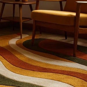 May include: A retro-style area rug with a wavy, striped pattern in shades of green, white, yellow, orange, and brown. The rug is placed under a mid-century modern chair and side table, creating a warm and inviting space.