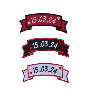 May include: Three embroidered banner patches in red, black, and white. Each banner displays the date "15.03.24" in white, with a small heart accent. The banners have a ribbon-like design, ideal for customisation.