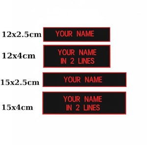 May include: Four black rectangular labels with red borders and text. The labels are labeled with the following dimensions: 12x2.5cm, 12x4cm, 15x2.5cm, and 15x4cm. The text on the labels reads "YOUR NAME" and "YOUR NAME IN 2 LINES".