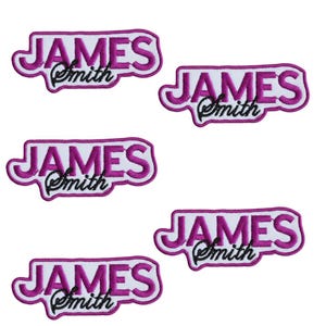 May include: Five embroidered patches featuring the name "JAMES Smith". The word "JAMES" is in a bold, purple font with a white outline, and "Smith" is in a cursive black font.