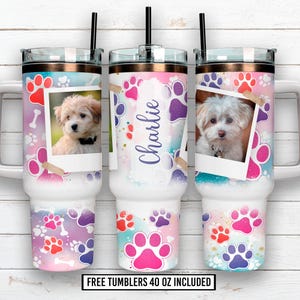 May include: Three white 40 oz tumblers with lids and straws. Each tumbler features a photo of a small dog, paw prints, and a watercolor background in pink, purple, and blue. One tumbler has the name "Charlie".