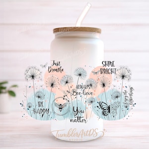 May include: White glass tumbler with a bamboo lid and a clear straw. The tumbler is decorated with a floral design, butterflies, and inspirational phrases like "Just Breathe" and "Shine Bright".