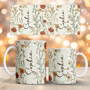May include: Two white ceramic mugs and a matching rectangular item, all featuring a floral design with red, yellow, and white flowers on a cream background. The name "Sophia" is written vertically on each item in a cursive font.