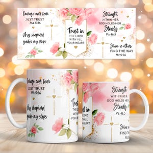 May include: White ceramic mugs with floral and inspirational text designs. The mugs feature pink roses, gold accents, and phrases like "Courage over fear" and "Trust in the Lord." A matching design is displayed above the mugs.
