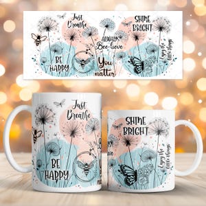 Puede incluir: Taza de cerámica blanca con un diseño floral e insectos. La taza presenta dientes de león, abejas y mariposas, con frases inspiradoras como "Just Breathe" y "Shine Bright" en texto negro. El diseño incluye detalles en acuarela rosa y azul.