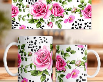 May include: Two white ceramic mugs with a floral design featuring pink roses, green leaves, and black polka dots. The design is also on a rectangular panel above the mugs. The mugs have white handles.