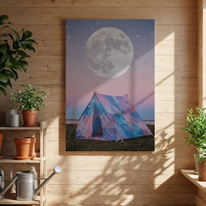 May include: A canvas print depicting a colourful tent beneath a large moon and starry sky. The tent is made of blue, purple, and pink patchwork. The scene evokes camping and nature.