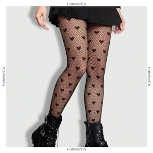 May include: Black fishnet tights with a heart pattern. The tights are worn with black boots. The image includes the text "HatellierCo" on the left and right sides.