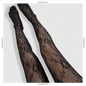 May include: Black tights featuring a detailed floral lace pattern with a fine mesh texture. The text HatelierCo is visible on the edges of the image. These sheer black hosiery items display an intricate botanical design across the entire surface.