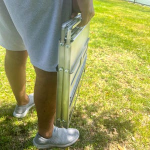 Ultra-slim foldable balcony BBQ in a soot-proof truck tarp bag, space-saving outdoor cooking gear for modern terraces, easy to store industrial design.