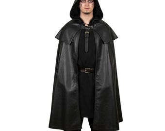 May include: Black hooded cloak with a leather-like appearance. The cloak features a capelet over the shoulders, a buckle closure at the neck, and a belt at the waist. The garment is designed for costume or cosplay.