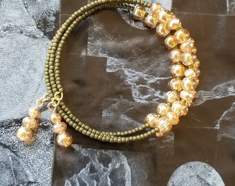 Stunning beaded memory wire three strand cuff bracelet. Sparkling orange and matte olive green. Free shipping!