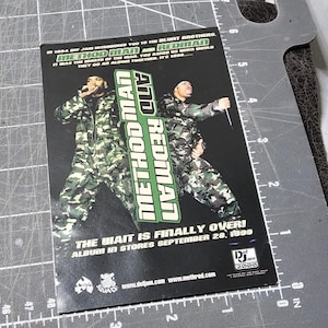 May include: A promotional poster for the album "Method Man and Redman." The image features two men in camouflage outfits, with the album title and release date prominently displayed. The poster has a black background.