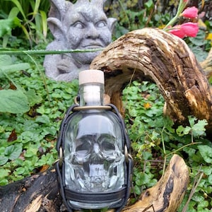 Skulldugger Boss- skull shaped glass bottle with leather belt loop attachment. A must for all discerning pirates & brigans on the high seas!