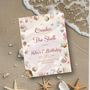 May include: A seashell-themed birthday invitation with the text "Oneder The Shell" and "Mila's 1st Birthday". The invitation features seashells, starfish, and pearls, with a soft, pastel color palette. The invitation is on a sandy beach.