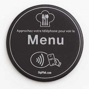 May include: A black, circular sign with white text and graphics. The sign features a chef's hat with cutlery, the word "Menu", and a phone with NFC. The text reads "Approchez votre téléphone pour voir le Menu" and "DigiPlak.com".