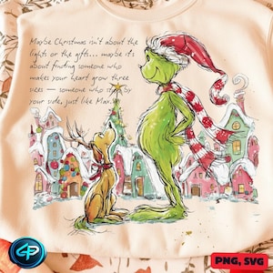 Puede incluir: Sudadera crema con una ilustración del Grinch y Max en un pueblo nevado. El Grinch, verde, lleva gorro y bufanda de Papá Noel. El texto dice: «Maybe Christmas isn't about the lights or the gifts...» Un diseño festivo.