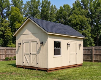 May include: A small, light-colored wooden shed with a black metal roof. The shed has two doors, a window, and three black outdoor lights. It is set on a grassy lawn with a wooden fence and trees in the background.