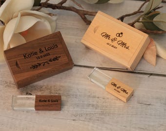 May include: Two wooden USB flash drive boxes, one dark brown and one light brown, with engraved text. The dark brown box reads "Katie & Louis 12-2-2023". The light brown box reads "Mr. & Mrs. 12-2-2023".