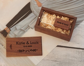 May include: Wooden USB drive and box set. The box is filled with wood shavings and includes a small wooden tag. The USB drive and tag are engraved with the names "Katie & Louis" and the date "12-2-2023", along with a crescent moon and leaf design.