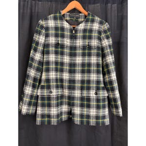 May include: A long-sleeve jacket featuring a plaid pattern in dark green, black, white, and yellow. The jacket has a round neckline, a full-length front zipper closure, and four front pockets with black buttons. The label reads Kasper & Company.