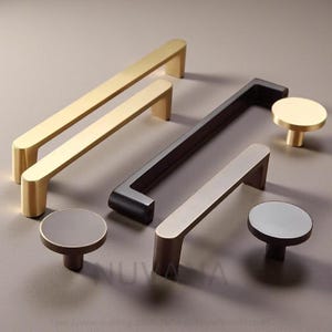 May include: A collection of modern cabinet hardware, including gold, black, and bronze-toned handles and knobs. The handles are rectangular, and the knobs are circular with a short stem. The hardware is displayed on a neutral background.