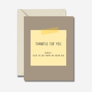 May include: A greeting card with a light beige envelope. The card has a brown background with a yellow sticky note attached with yellow tape. The text on the note reads: "THANKFUL FOR YOU. SERIOUSLY. YOU'RE THE ONLY NORMAL ONE AROUND HERE."
