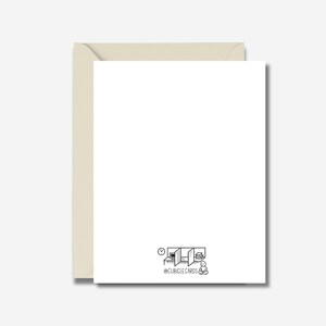 May include: A blank white greeting card with a light beige envelope. The card features a small black and white illustration of a cubicle scene with a clock, computer, and person. The text "@CUBICLECARDS" is below the illustration.