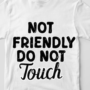 May include: White t-shirt featuring the black text "NOT FRIENDLY DO NOT TOUCH". The text is in a bold font and is centered on the shirt. The t-shirt has short sleeves and a crew neck. The fabric appears to be soft.