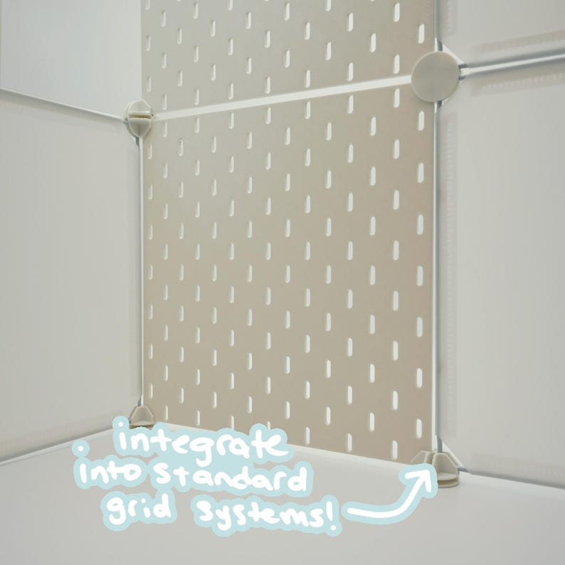 May include: A beige pegboard panel with a repeating pattern of vertical slots, secured within a white modular grid system by circular connectors. The text "integrate into standard grid systems!" is written in light blue on the lower section.