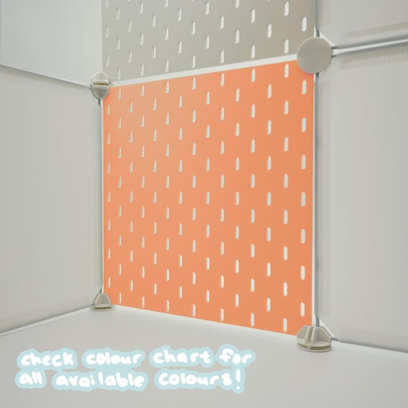 May include: A modular storage cube system featuring a bright orange pegboard panel with vertical slots, connected by white plastic corner joints. The text "check colour chart for all available colours!" is printed in white at the bottom.