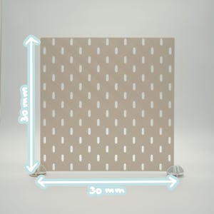 May include: A square beige pegboard panel featuring a grid of vertical oval slots. The panel is supported by two small white plastic feet at the base. The image includes light blue arrows and text indicating dimensions of 30 mm by 30 mm.