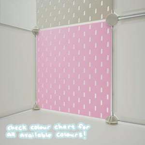 May include: A modular storage cube system featuring a pink pegboard panel with a repeating pattern of vertical white slots. The unit is assembled with light gray corner connectors. Text at the bottom reads: check colour chart for all available colours!