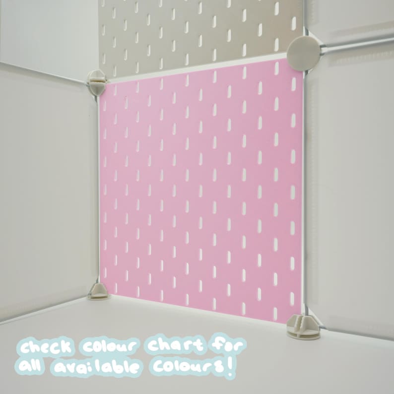 May include: A modular storage cube system featuring a pink pegboard panel with a repeating pattern of vertical white slots. The unit is assembled with light gray corner connectors. Text at the bottom reads: check colour chart for all available colours!