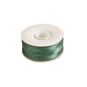 May include: A spool of dark sage green thread wound tightly around a white plastic core. The thread has a smooth, slightly lustrous finish and is wrapped in a crisscross pattern across the cylindrical spool, showing a consistent color throughout.