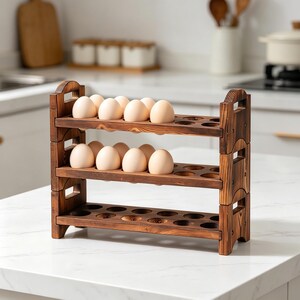 May include: A three-tiered wooden egg holder, stained a warm brown, filled with a dozen eggs. The rustic design features cut-out holes for each egg and handles on the sides. Perfect for kitchen organization.
