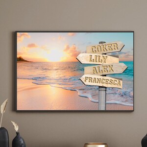 May include: Framed beach scene with a sunset over the ocean. A wooden signpost with arrows points towards "Goker", "Lily", "Alex", and "Francesca". The artwork is displayed above a dark wooden cabinet with decorative vases and a gold bowl.