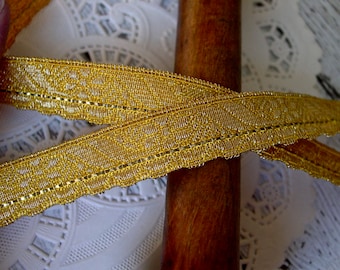 May include: Gold trim with a delicate pattern and a metallic sheen. This trim is perfect for adding a touch of elegance to any project.