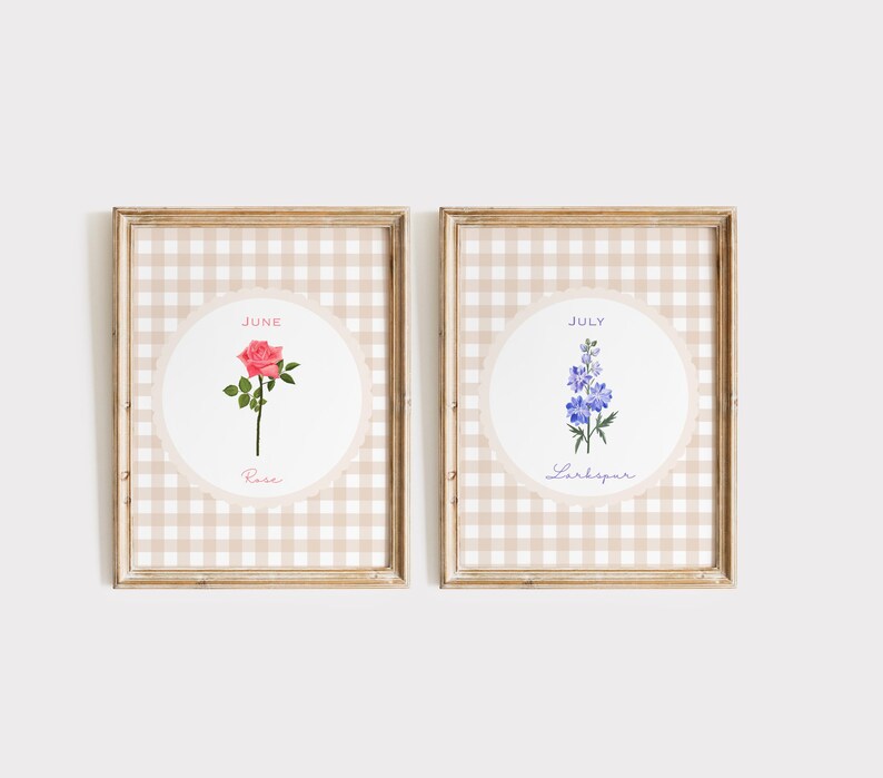 May include: Two framed floral art prints. One features a pink rose with the text "June" and "Rose." The other print displays a blue Larkspur with the text "July" and "Larkspur." Both are set against a beige gingham background.