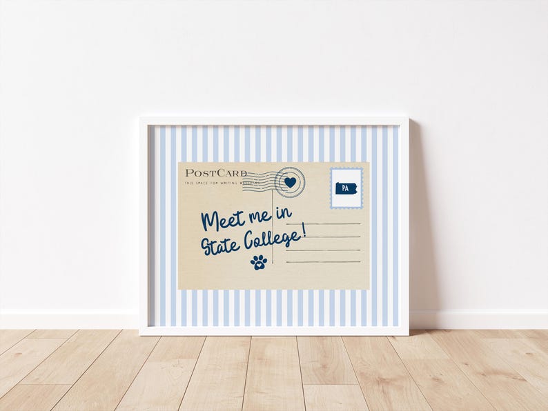 May include: A framed postcard print with a blue and white striped background. The postcard is tan with the text "Meet me in State College!" in navy blue script. A paw print and a Pennsylvania stamp are also featured.