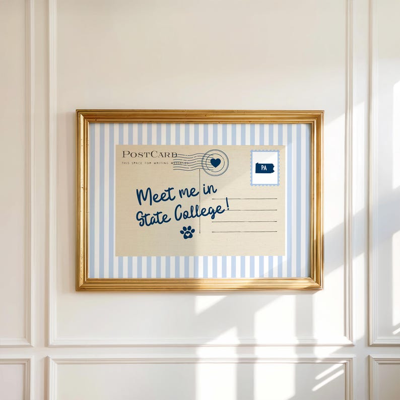 May include: A framed postcard print with a gold frame. The postcard features blue and white stripes and the text "Meet me in State College!" in blue script. A blue paw print and a heart are also visible.