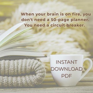 May include: An open book with yellowed pages rests on a folded gray knit blanket. A white mug with "INSTANT DOWNLOAD PDF" is to the right. Text above reads: "When your brain is on fire, you don't need a 50-page planner. You need a circuit breaker."