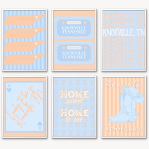 May include: Six framed art prints with a light blue and peach color scheme. The prints feature text and illustrations related to Knoxville, Tennessee. Designs include Tennessee state outlines, ticket stubs, and a cowboy boot.