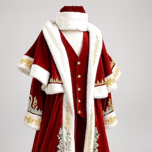 May include: A festive red velvet costume with white faux fur trim and gold embroidery. The ensemble includes a long coat, vest, and hat. The coat features ornate gold leaf and scroll designs, perfect for a holiday or theatrical event.