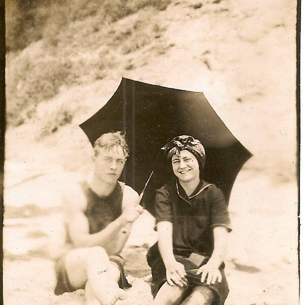 Early 1900's  photo .Man and woman under umbrella at Laguna Beach