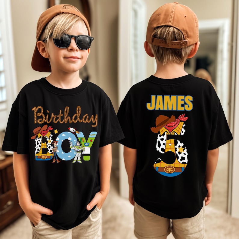May include: Black t-shirt with "Birthday Boy" text and Toy Story characters. The number "5" is on the back, along with the name "James". The shirt has a brown cowboy hat and a cow print.