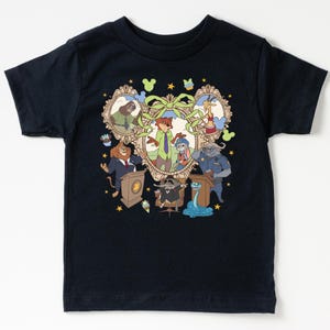 May include: A navy blue t-shirt featuring a colorful cartoon illustration of characters from the movie Zootopia. The design includes framed portraits of various animals, with a central image of Nick Wilde and Judy Hopps. The shirt has a crew neck and short sleeves.
