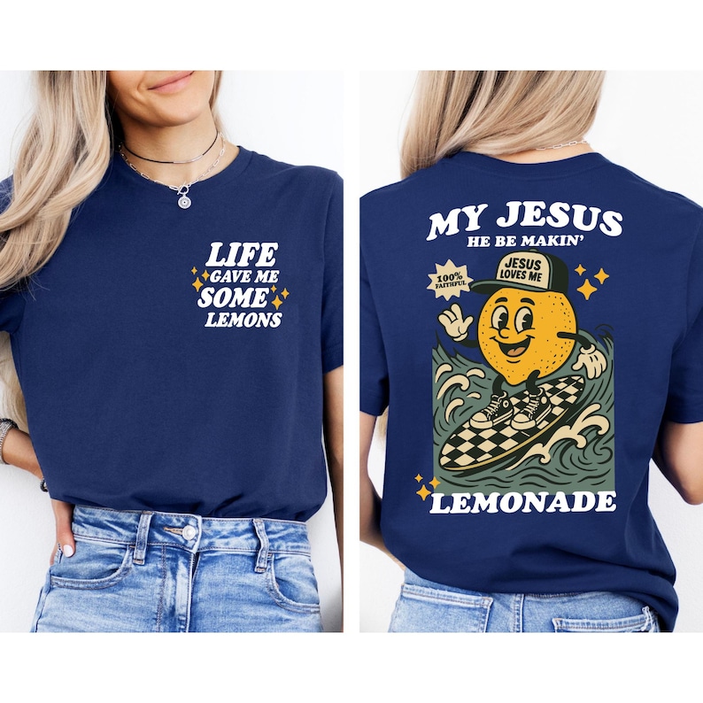 Puede incluir: Camiseta azul marino con el texto "LIFE GAVE ME SOME LEMONS" en la parte delantera. La parte trasera presenta un lim&oacute;n de dibujos animados surfeando con el texto "MY JESUS HE BE MAKIN'" y "LEMONADE".